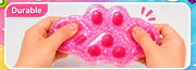 Hand pressing a pink paw-shaped squishy, supplier demonstration